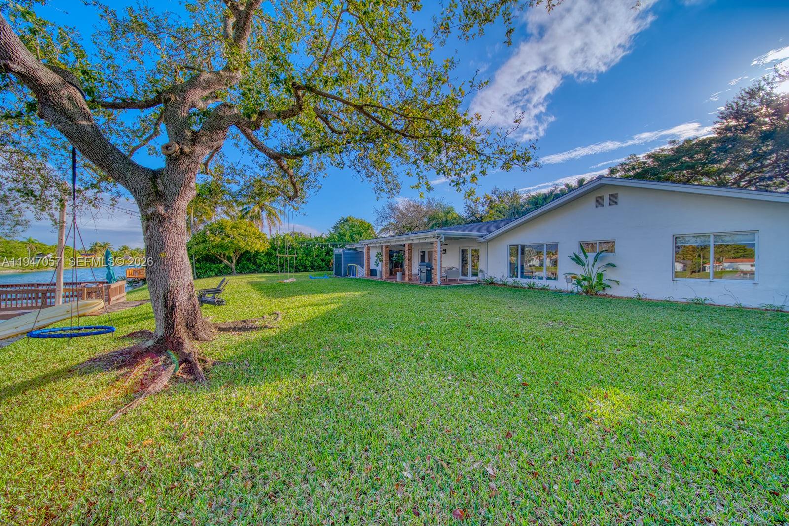 12620 Southwest 114th Avenue Miami, FL 33176 - Photo 29 of 37 a view of a house with a backyard