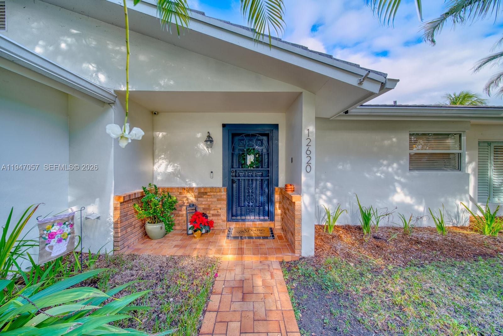 12620 Southwest 114th Avenue Miami, FL 33176 - Photo 3 of 37 a front view of a house with potted plants