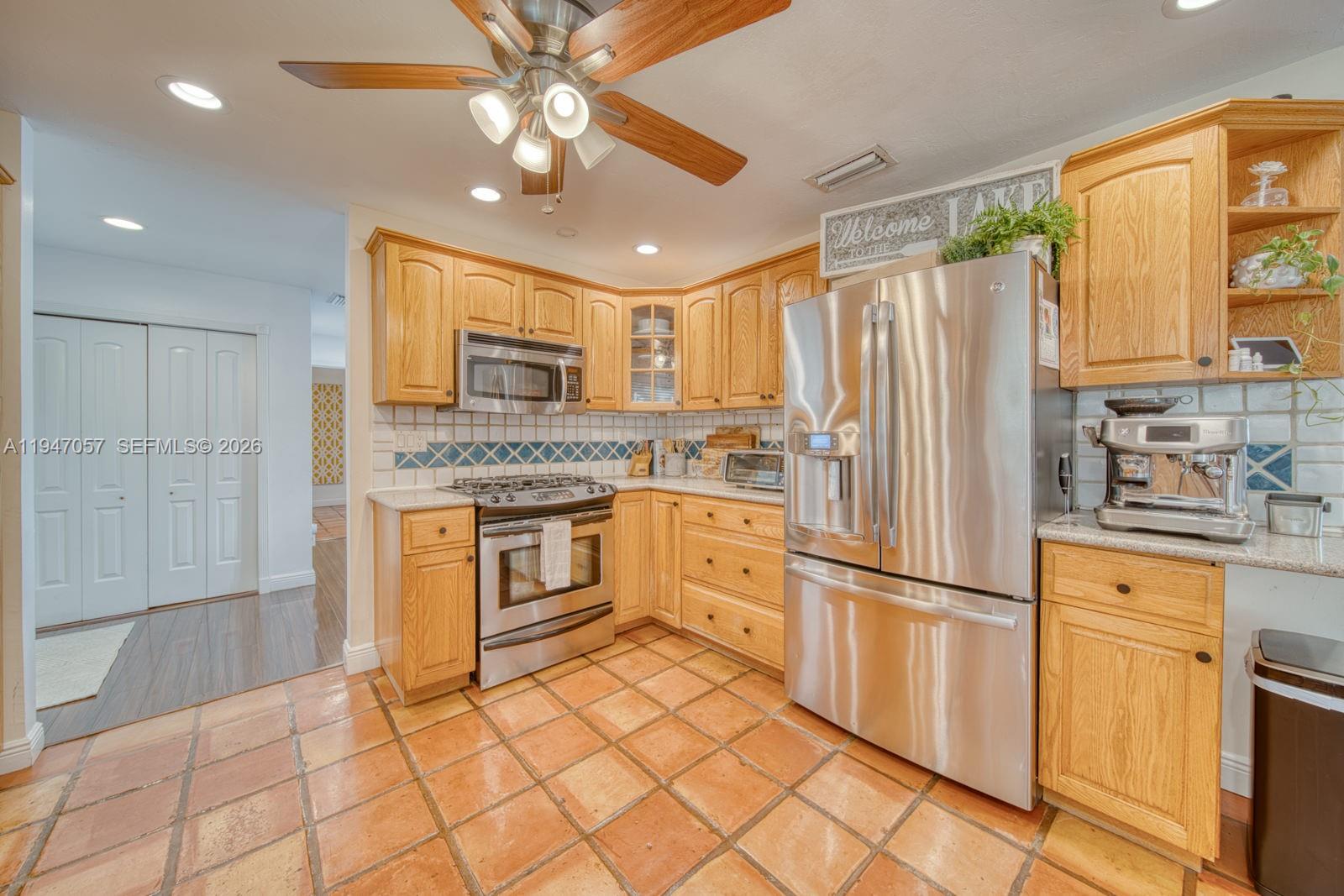 12620 Southwest 114th Avenue Miami, FL 33176 - Photo 10 of 37 a kitchen with granite countertop a refrigerator and a sink
