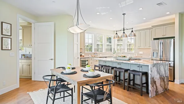 a large kitchen with a table and chairs