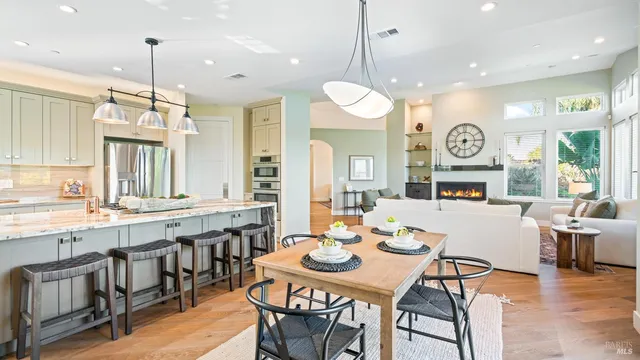 a kitchen with stainless steel appliances granite countertop a stove and a large window