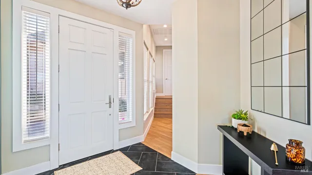 a dining room with furniture a chandelier and wooden floor