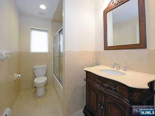 a bathroom with a sink a toilet and mirror