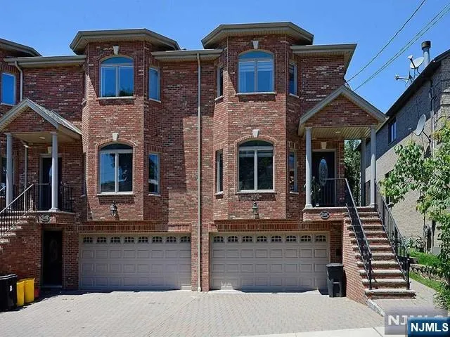 a front view of a house with many windows