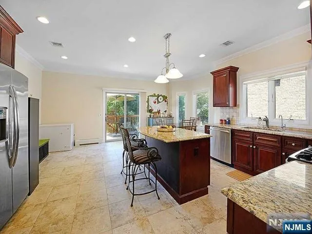 a kitchen with a sink a counter top space and stainless steel appliances