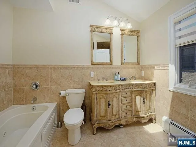 a bathroom with a granite countertop toilet a sink and a bathtub