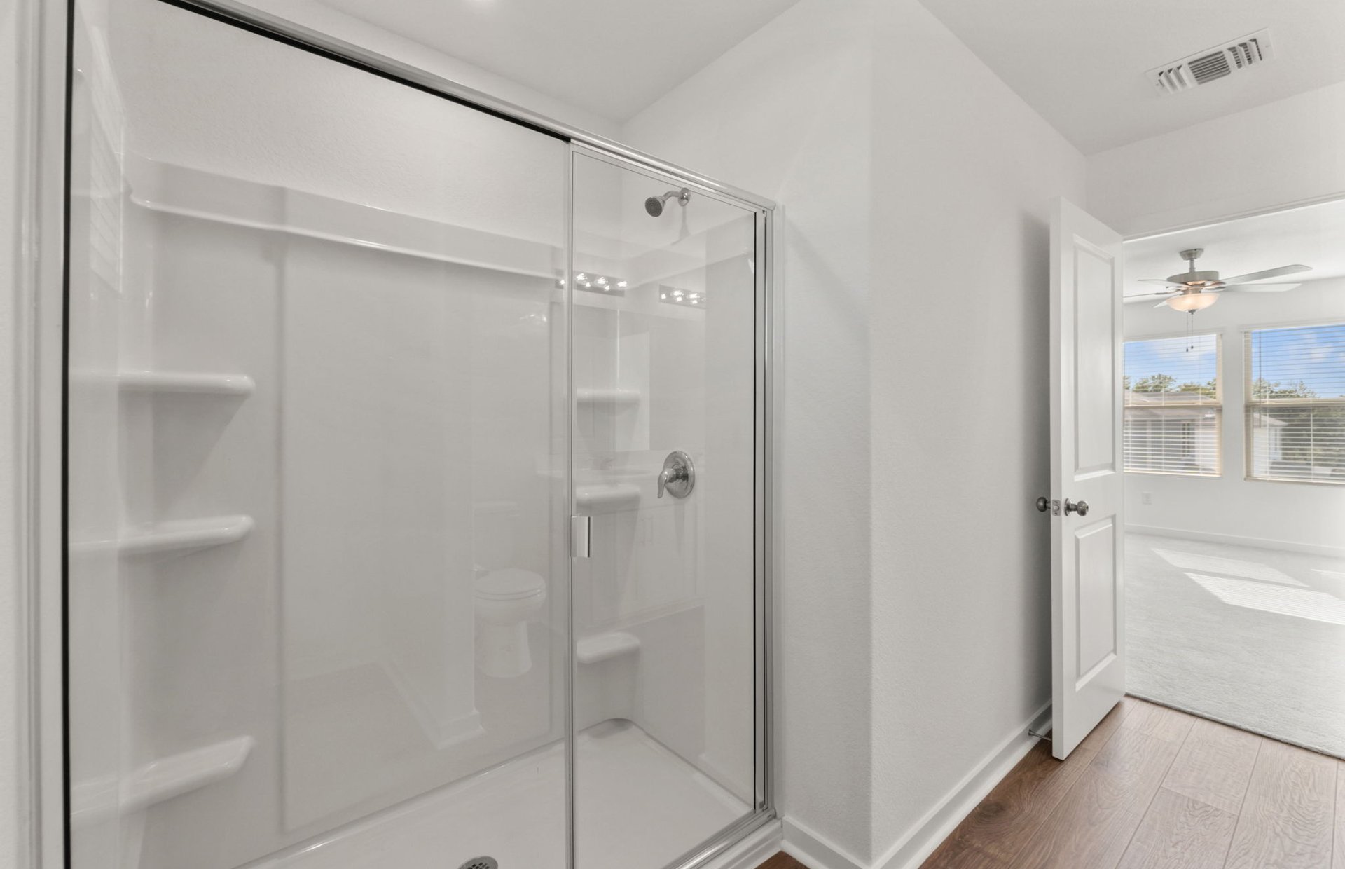 590 Rubber Tree Way Buda, TX 78610 - Photo 9 of 22 a bathroom with a glass shower door