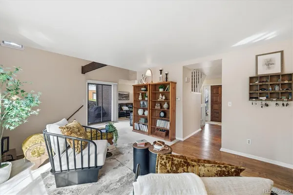 a living room with furniture and wooden floor