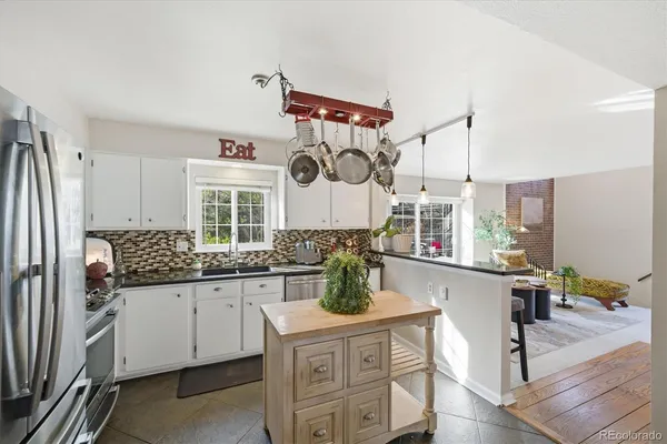 a kitchen with stainless steel appliances granite countertop a sink and cabinets