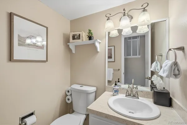 a bathroom with a sink a mirror and a toilet