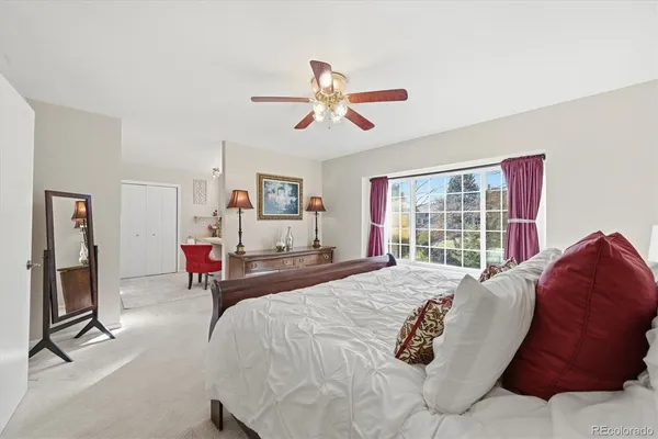a bedroom with a large bed and a chandelier