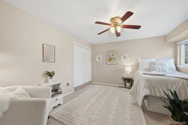 a spacious bedroom with a bed and a chandelier