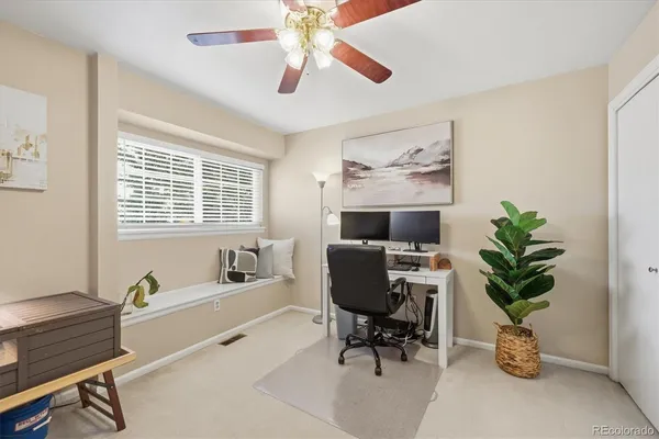 a livingroom with workspace and a window