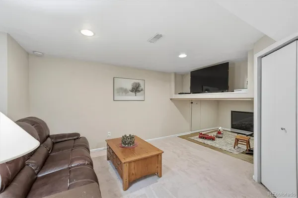 a living room with furniture and kitchen