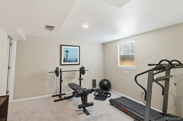 a utility room with dryer washer and a view of living room