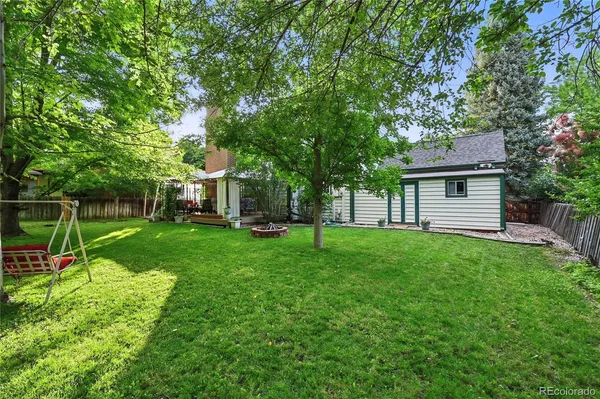 a view of a house with backyard and sitting area
