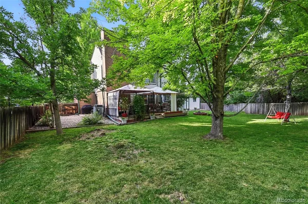 a view of a house with backyard sitting area and garden