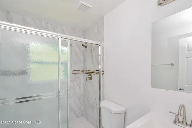 a bathroom with a shower and a toilet