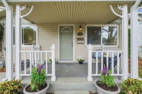 a front view of a house with plants