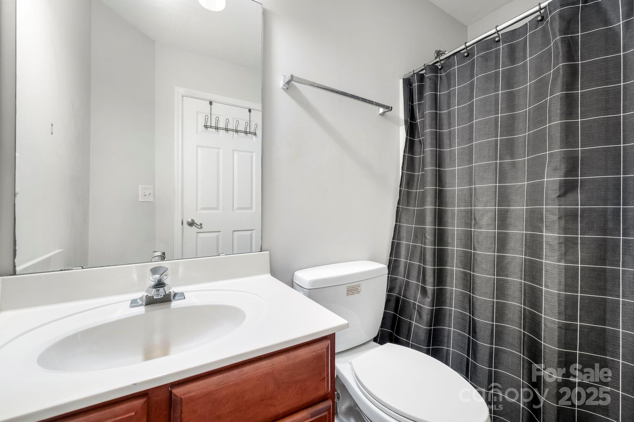 9919 Treeside Lane Matthews, NC 28105 - Photo 13 of 16 a bathroom with a sink a toilet and shower