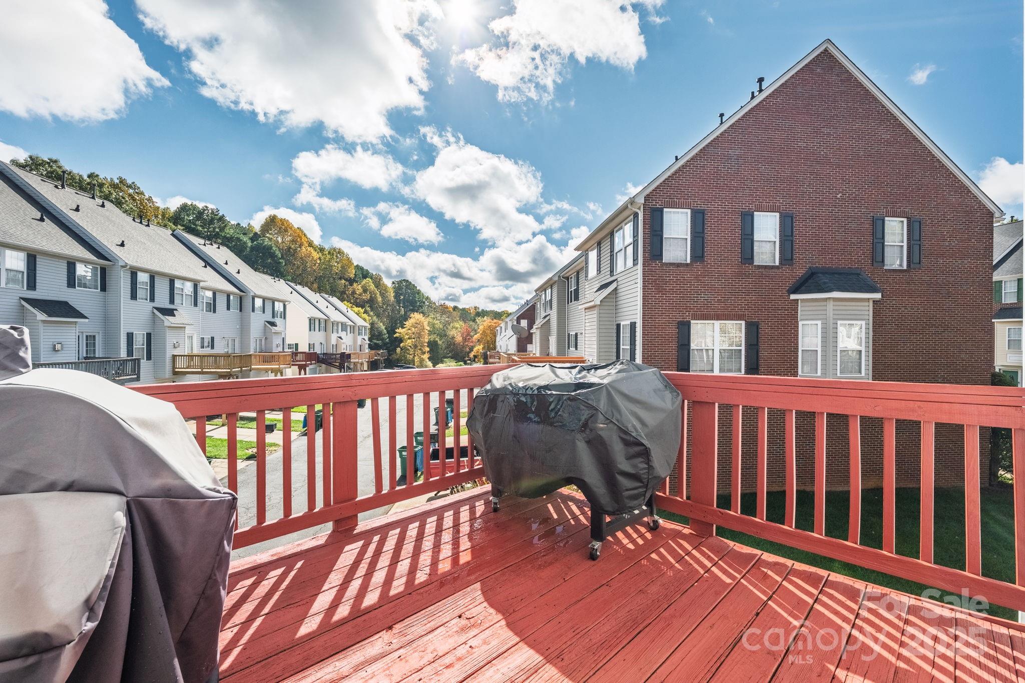 9919 Treeside Lane Matthews, NC 28105 - Photo 15 of 16 a view of a brick house with wooden deck
