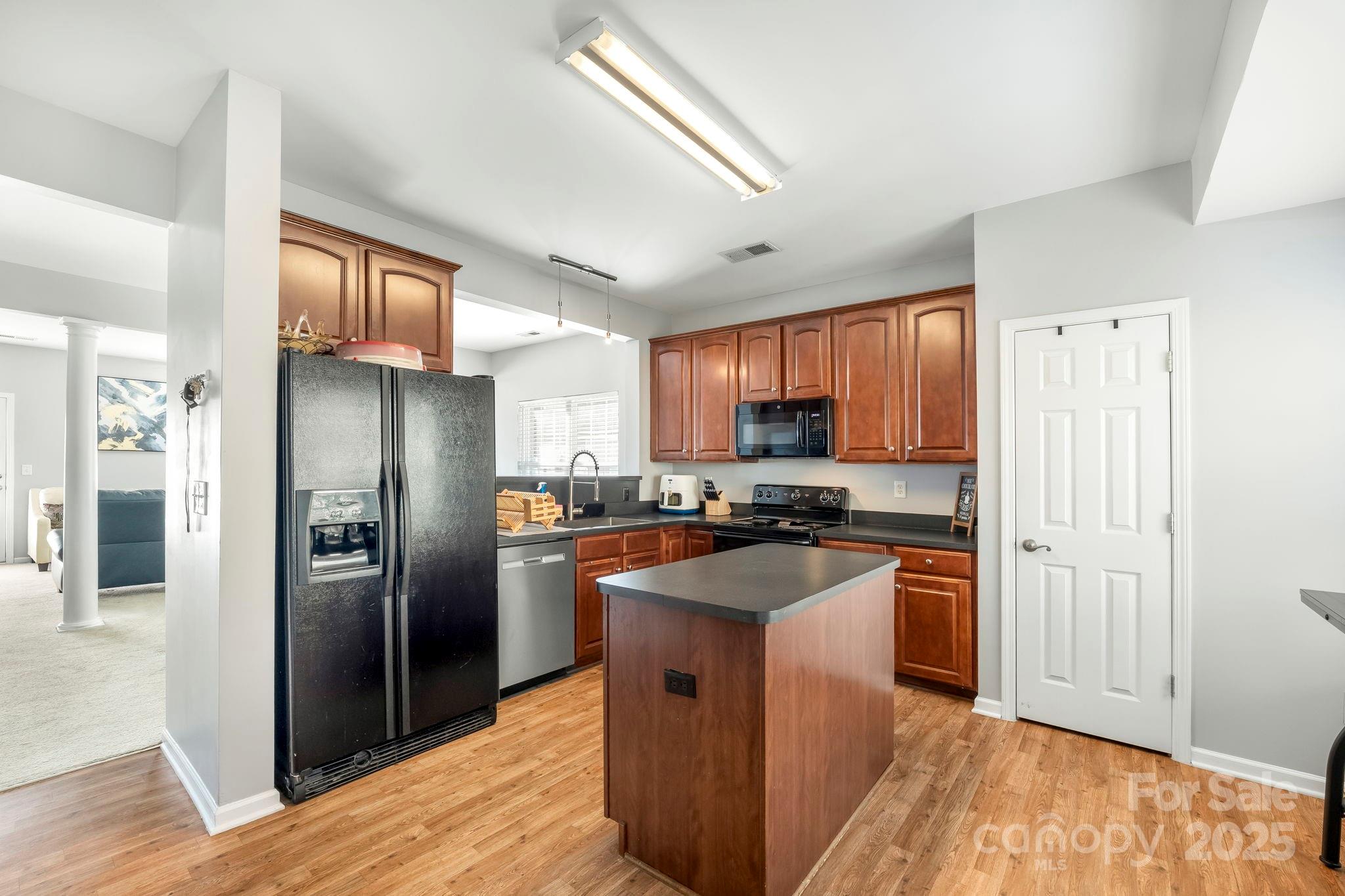 9919 Treeside Lane Matthews, NC 28105 - Photo 7 of 16 a kitchen with stainless steel appliances granite countertop a refrigerator a sink dishwasher a stove top oven a refrigerator and cabinets