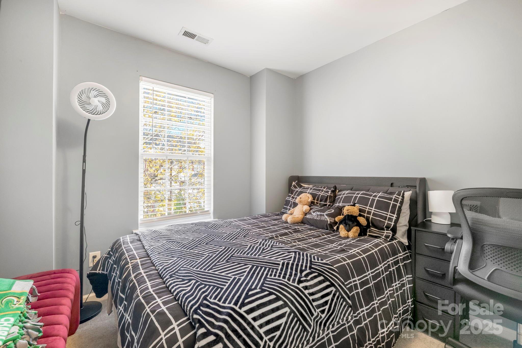 9919 Treeside Lane Matthews, NC 28105 - Photo 10 of 16 a bed sitting in a bedroom next to a window