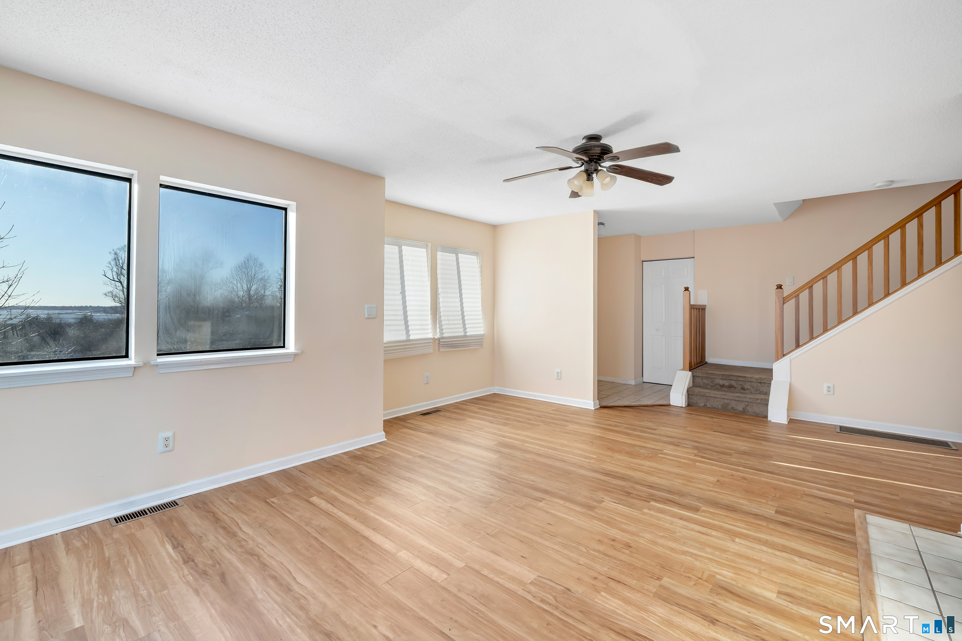 675 Townsend Avenue, Unit 104 New Haven, CT 06512 - Photo 24 of 40 a view of an empty room with a window and wooden floor