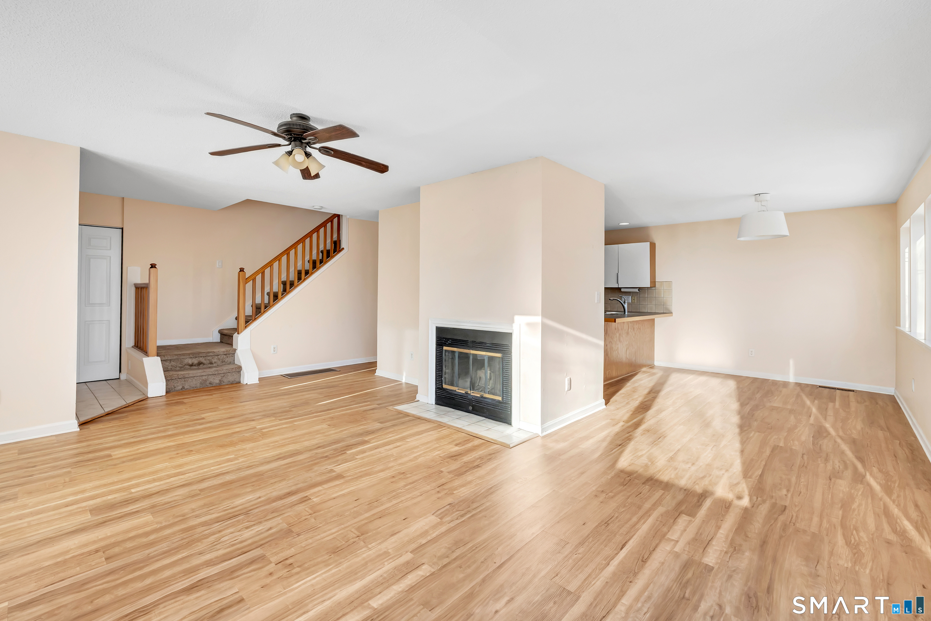 675 Townsend Avenue, Unit 104 New Haven, CT 06512 - Photo 25 of 40 a view of a livingroom with wooden floor and a fireplace