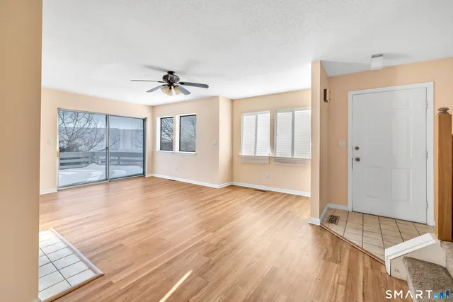 wooden floor in an empty room with a window