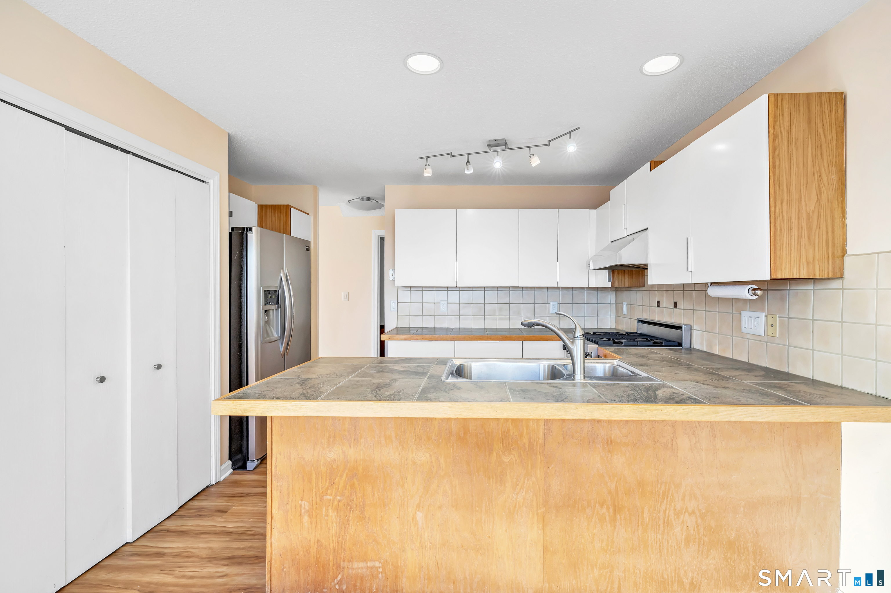675 Townsend Avenue, Unit 104 New Haven, CT 06512 - Photo 31 of 40 a kitchen with stainless steel appliances granite countertop a sink refrigerator and cabinets