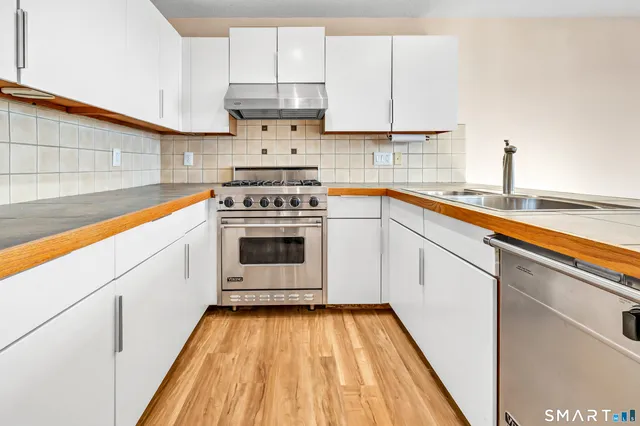 a kitchen with cabinets a sink and appliances