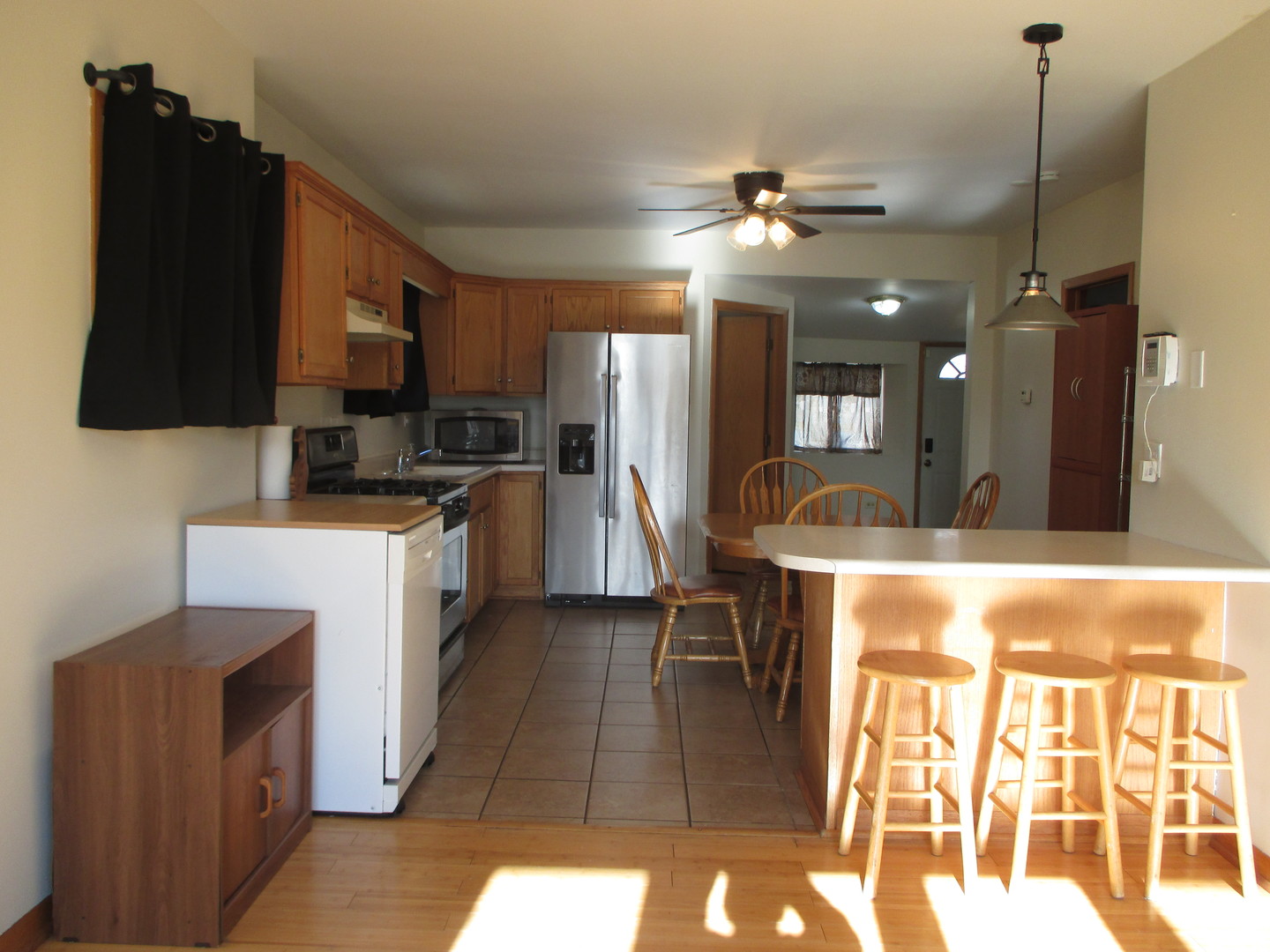 3902 Claire Boulevard Midlothian, IL 60445 - Photo 4 of 14 a kitchen with kitchen island granite countertop a sink cabinets and stainless steel appliances
