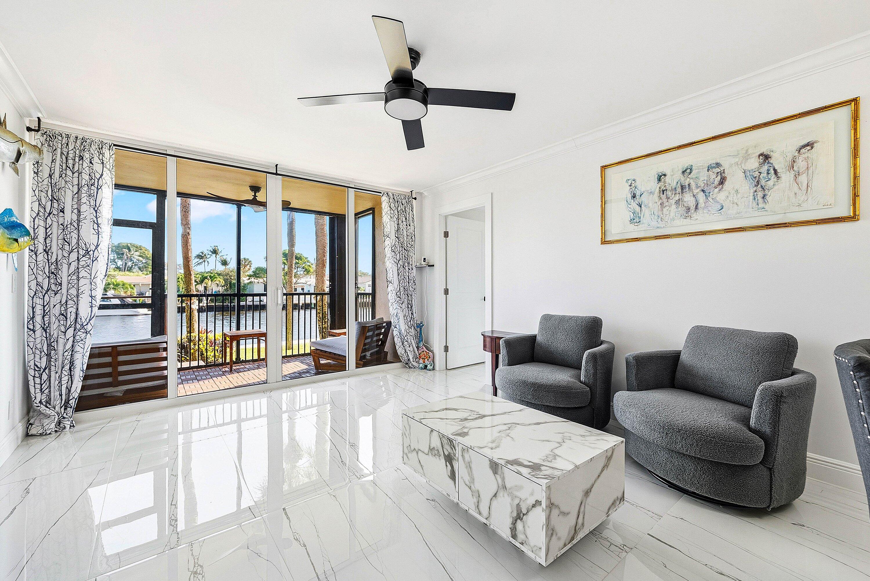 18 Royal Palm Way, Unit 109 Boca Raton, FL 33432 - Photo 11 of 43 a living room with furniture and a large window