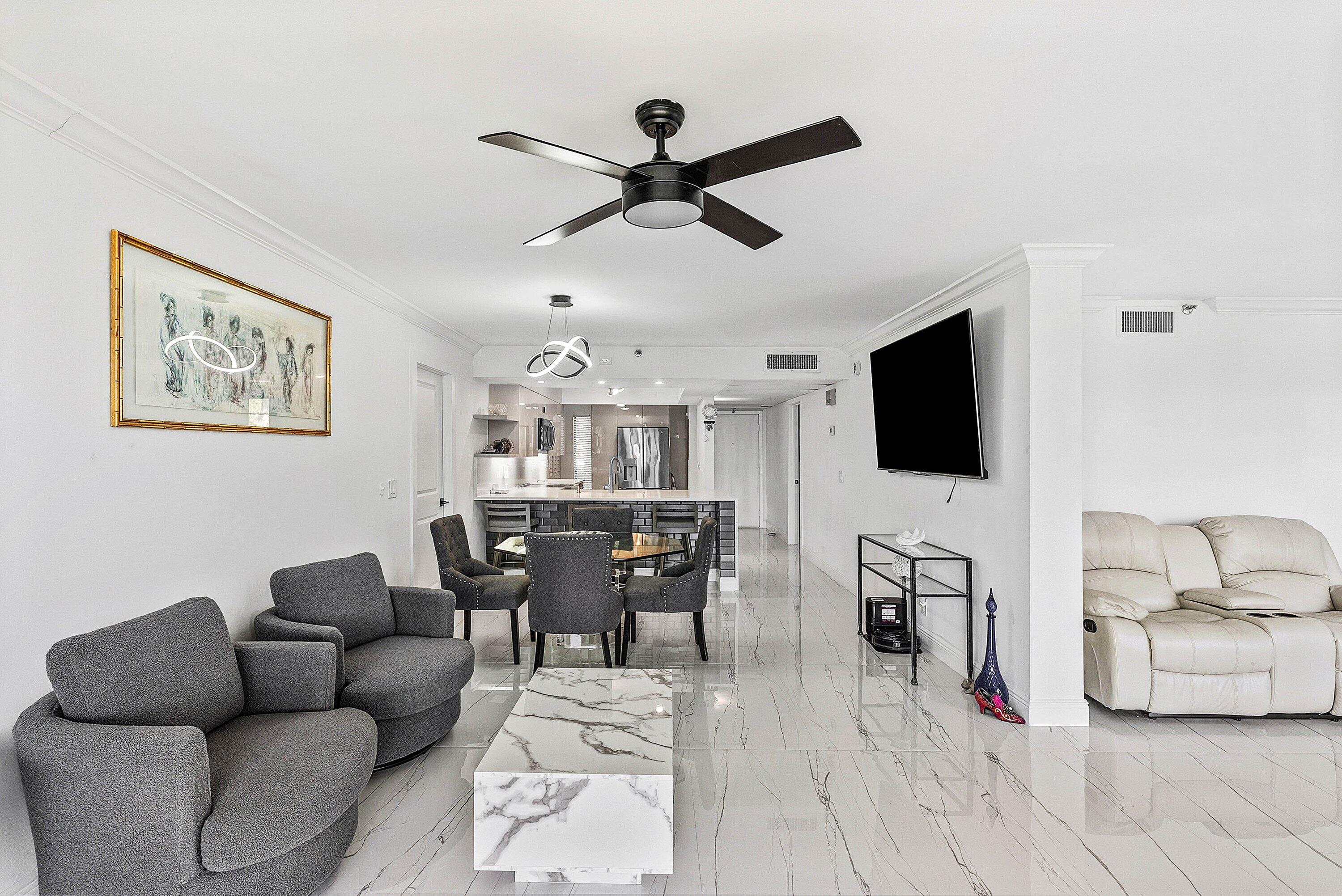 18 Royal Palm Way, Unit 109 Boca Raton, FL 33432 - Photo 13 of 43 a living room with furniture and a flat screen tv