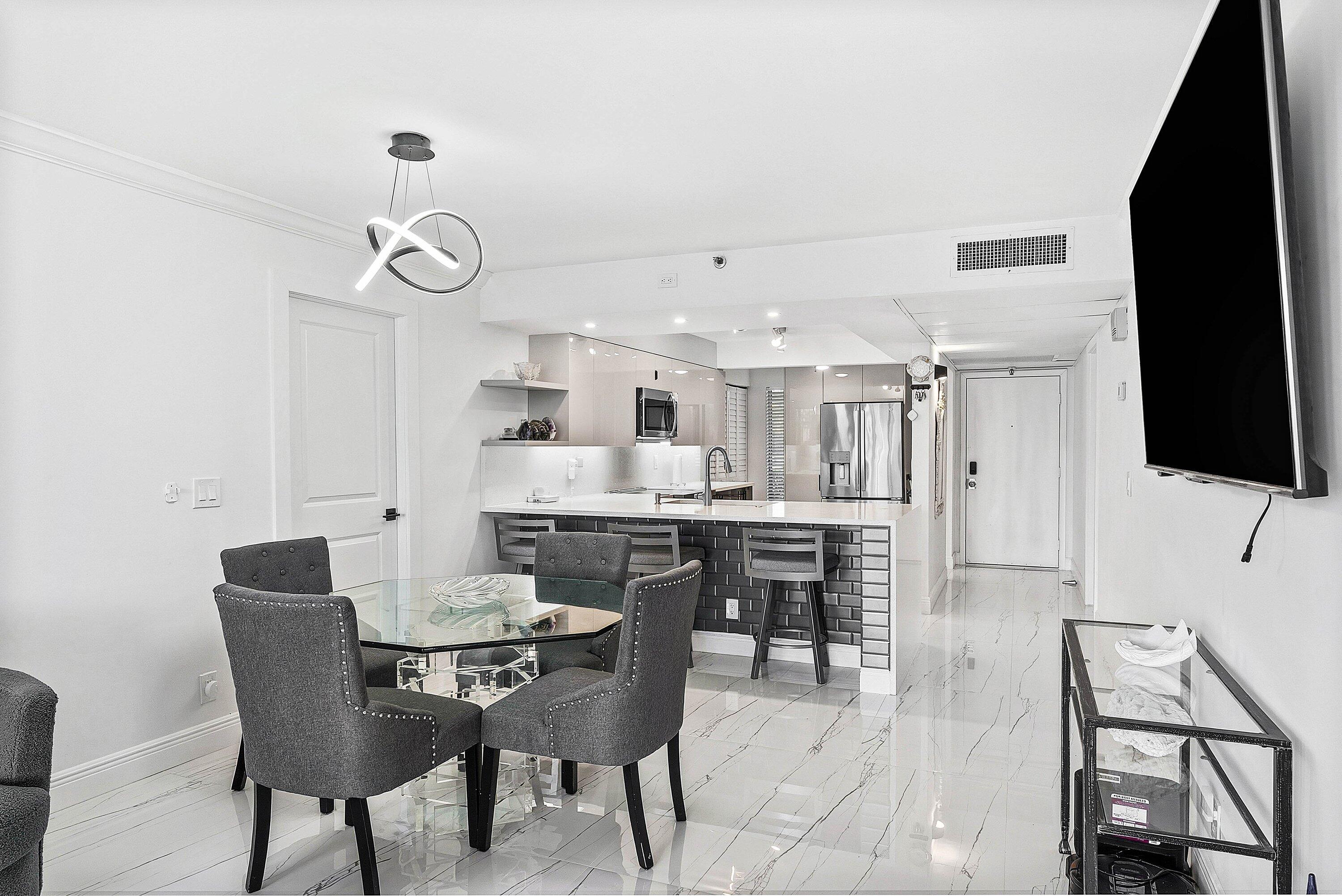 18 Royal Palm Way, Unit 109 Boca Raton, FL 33432 - Photo 14 of 43 a dining room with furniture and window