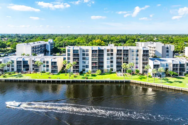 an aerial view of lake and residential houses with outdoor space