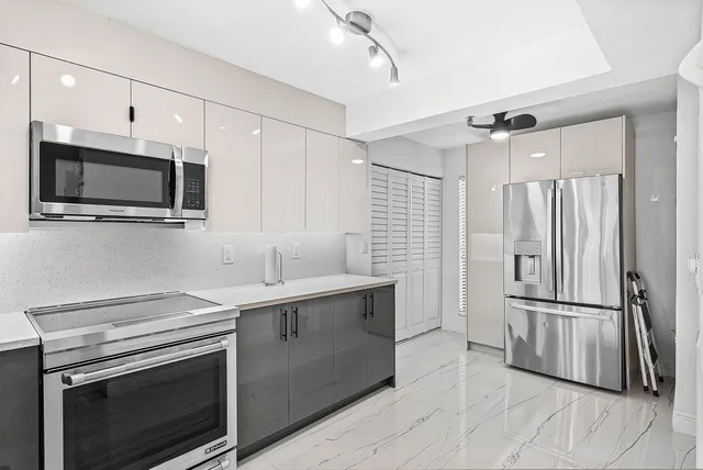 a kitchen with a sink stove and refrigerator