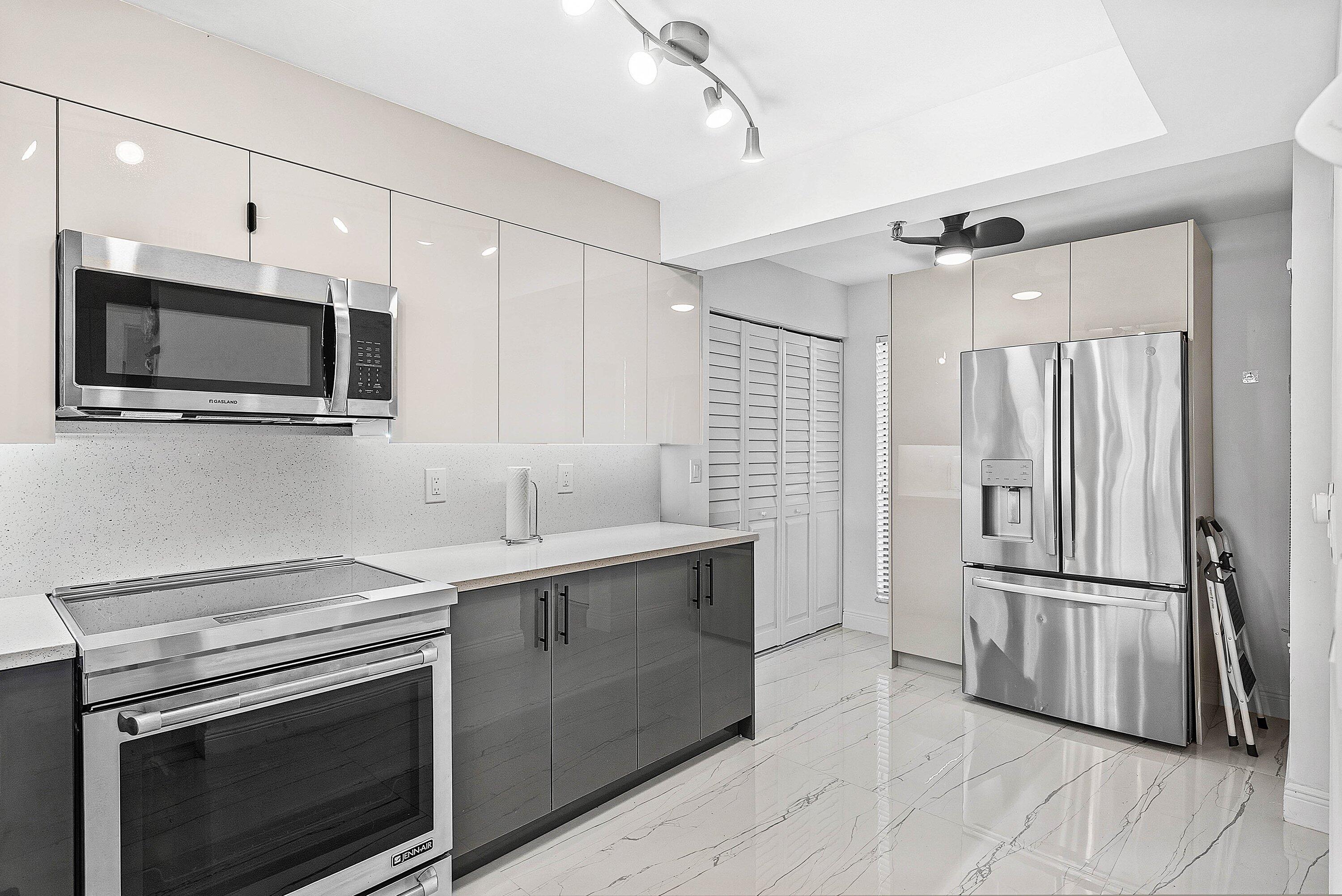 18 Royal Palm Way, Unit 109 Boca Raton, FL 33432 - Photo 6 of 43 a kitchen with a sink stove and refrigerator