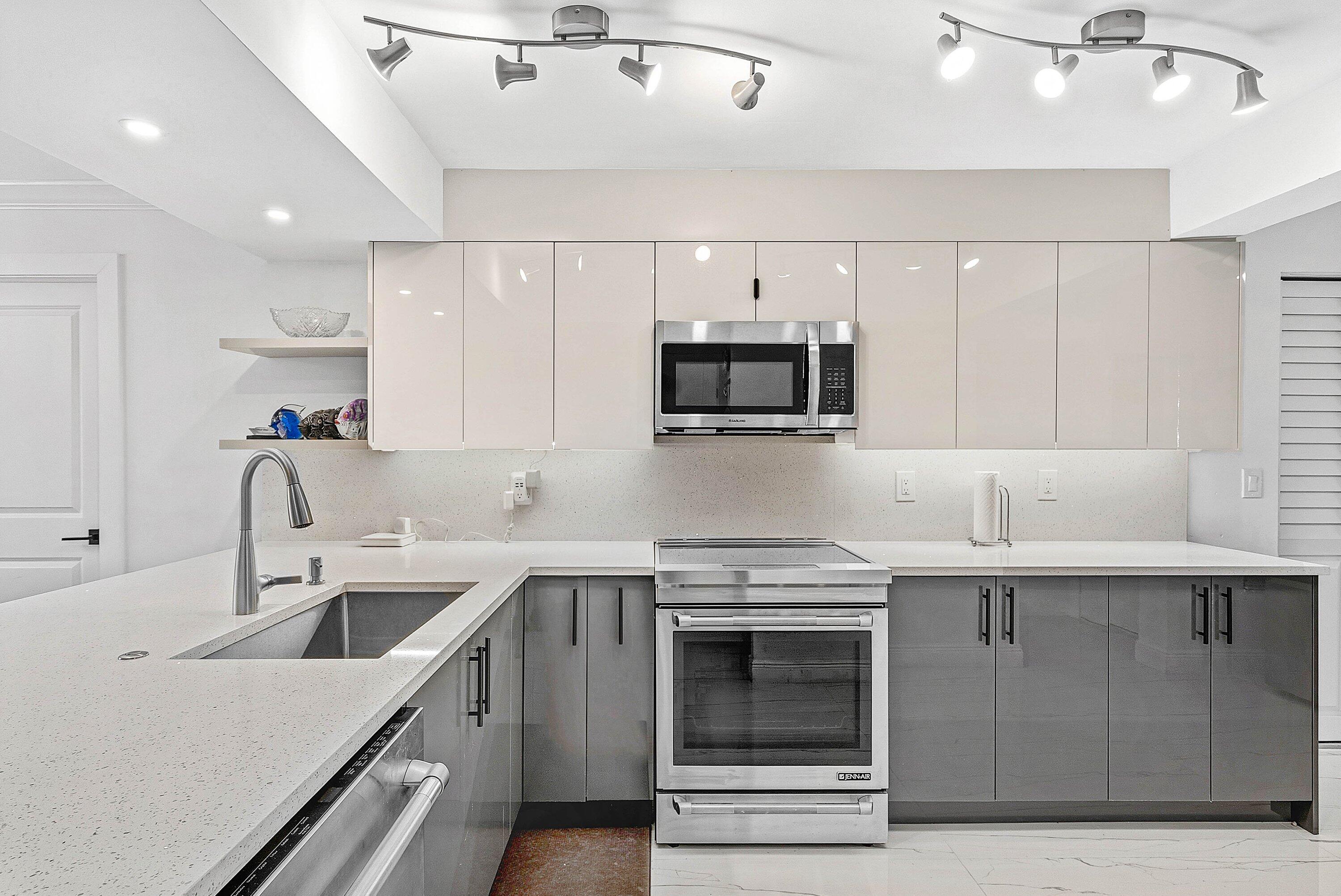 18 Royal Palm Way, Unit 109 Boca Raton, FL 33432 - Photo 7 of 43 a kitchen with a sink a stove and cabinets