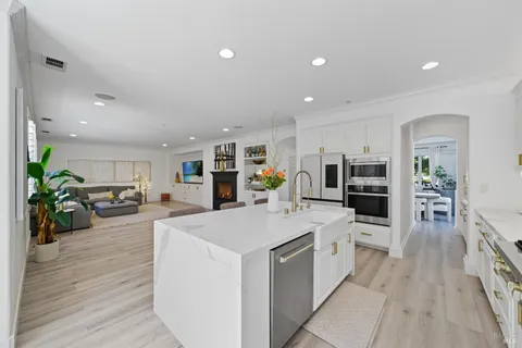 a view of a livingroom with entryway and a fireplace
