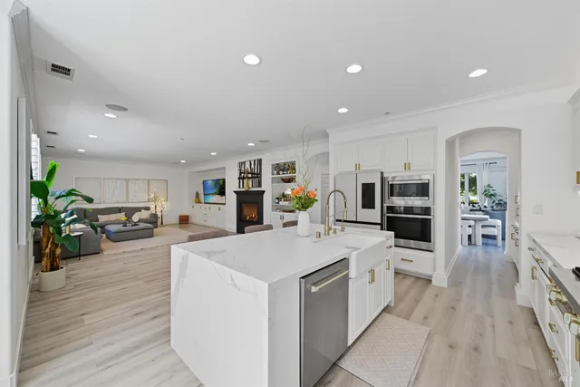 a view of a livingroom with entryway and a fireplace