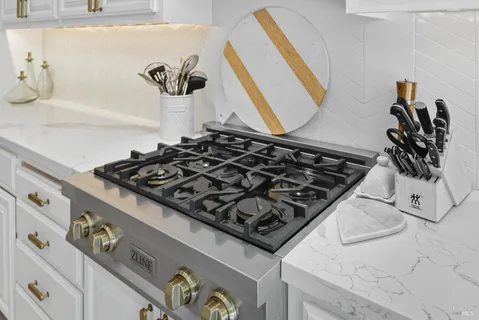 a view of a room with a large window and wooden floor