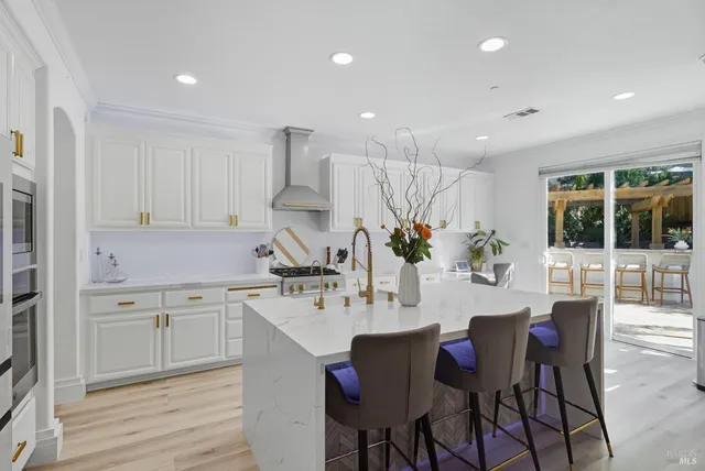 a view of a chairs and tables in the patio and a fountain
