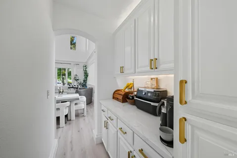 a view of a building with sitting area and palm trees