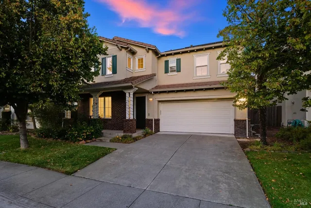 a front view of a house with potted plants