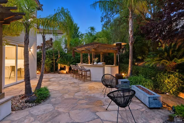 a view of a patio with table and chairs and potted plants