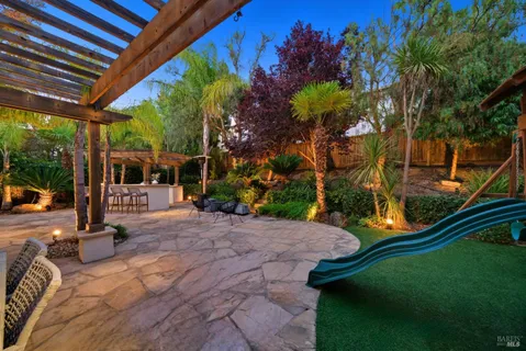 a view of patio with a table and chairs