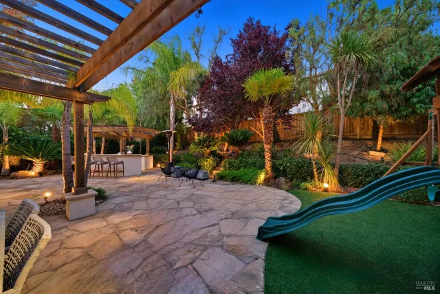 a view of patio with a table and chairs