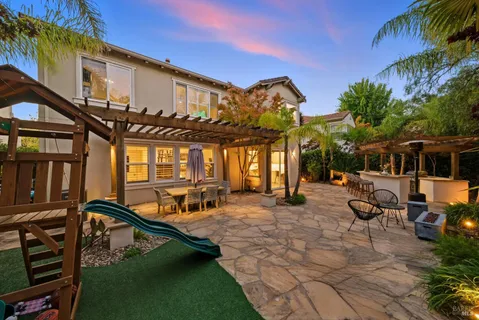 a view of a patio with a table and chairs
